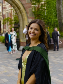 Maddie  waits her turn for a snap under 'the' arch.